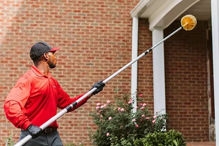 Tech sweeping entry on exterior of brick home