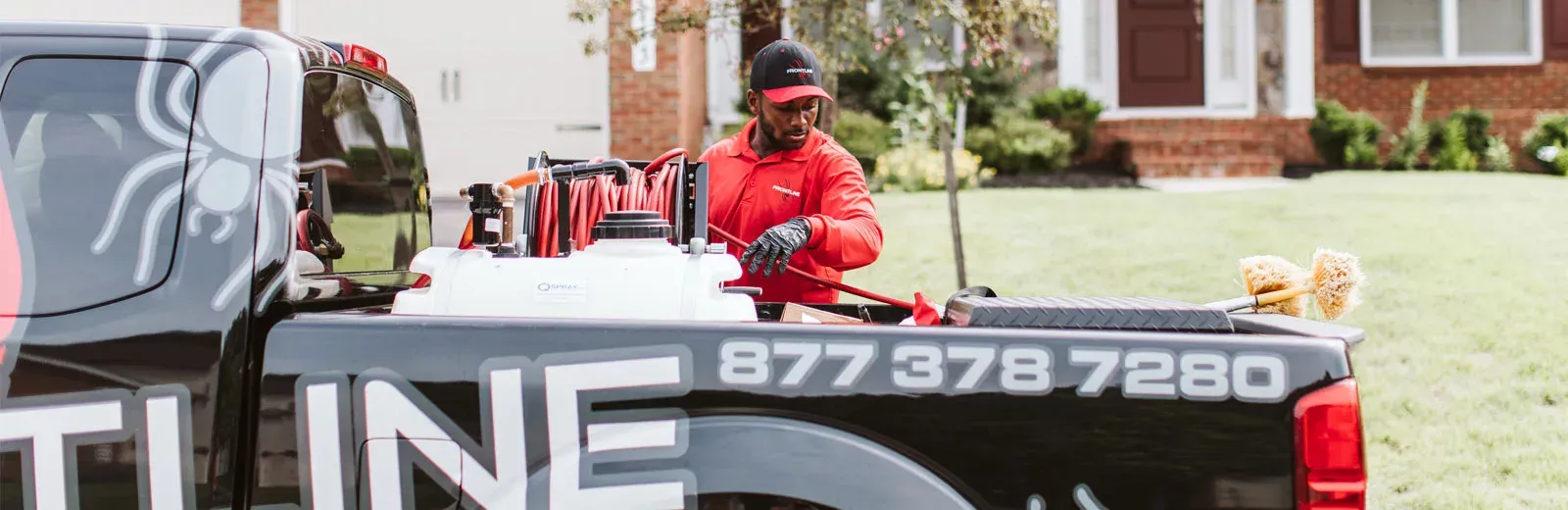 Frontline pest tech getting equipment from truck