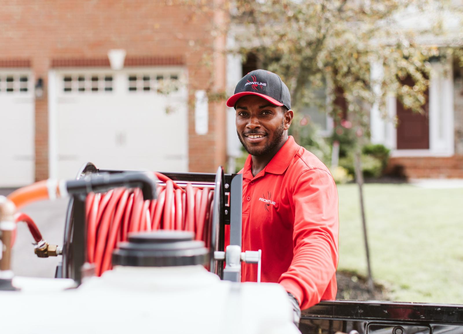 technician-smiling-standing-at-truck