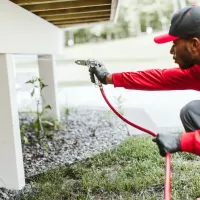 Technician conducting a termite inspection and service